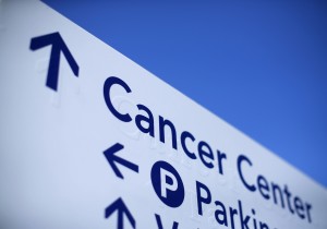 A sign pointing to the Rebecca and John Moores UCSD Cancer Center DNA Sequencing facility at the UCSD in San Diego